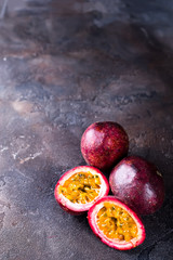 Passion fruits on dark table