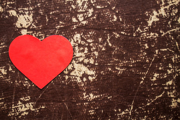 Red heart on the wooden background.