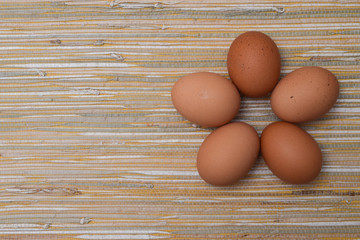 Chicken eggs in the straw tablecloth background