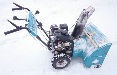 Blue snow blower isolated on white snow