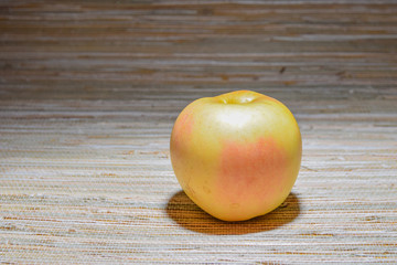 apple on straw tablecloth