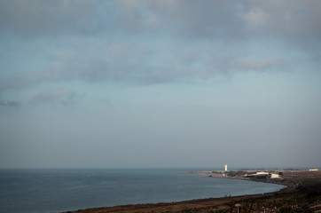 A view of the Mediterranean Sea, lighthouse and a landscape of the southern coast of Spain