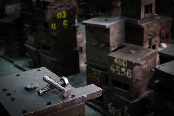 Screw bolts on old machines or molds in old factory.