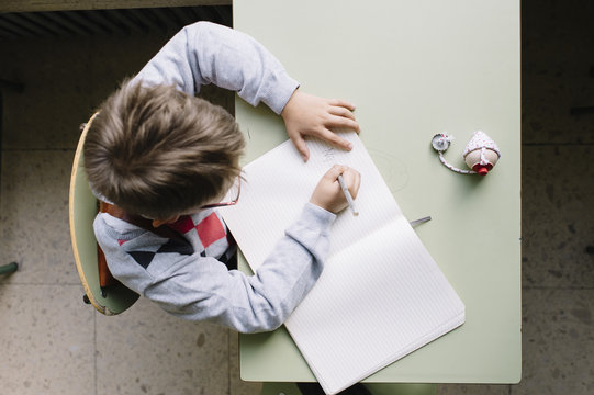 Little boy writing to the copy book