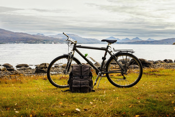 Naklejka na ściany i meble Bicycle and travel bag near the sea