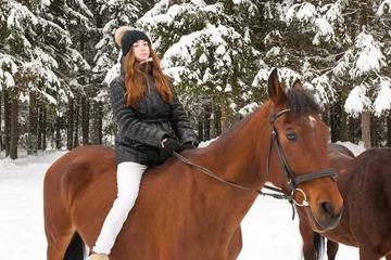Foto op Canvas Young girl and horse in a winter forest © keleny