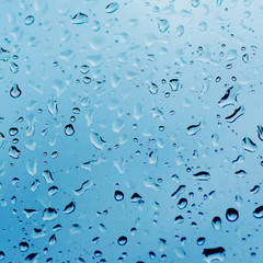 Rainy wet cold blue abstract eco seasonal natural blurred background with water drops