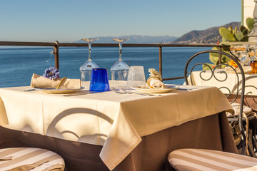 Table set in Italian restaurant in front of Camogli Bay, near Ge