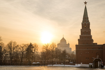 Naklejka premium Borovitsky tower and gate of Moscow Kremlin and Christ the Savior cathedral at sunset 