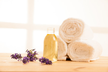 Towels lavender and masage oil on a table in spa salon