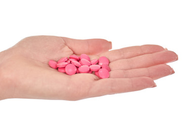 female hand with colorful pills isolated on white