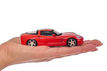 new red car on hand isolated on white