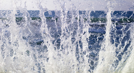 Clear water, blue background. Water splash