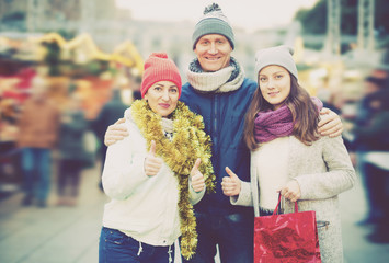 Ordinary parents with teen girl in market