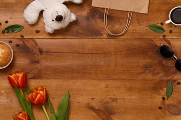 Red tulips and teddy bear in the wooden table. Banner template layout mockup for Woman Day, Valentines Day and Teacher's Day. 