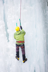 The climber climbs on ice.