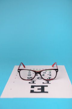glasses lying on snellen test chart