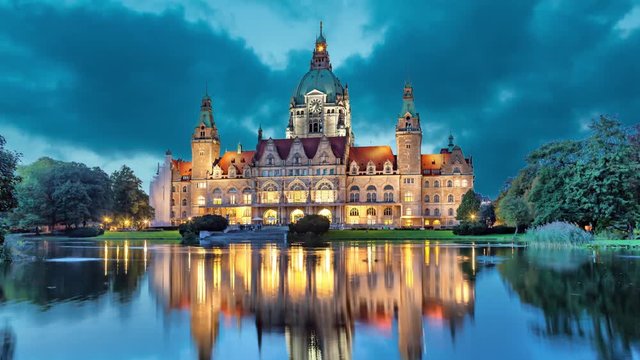 New City Hall of Hannover reflecting in water in the evening  (static image with animated sky)
