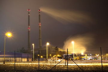 coal heating plant in the winter smog season, power plant with two chimneys at night