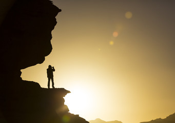 Silhouette of a man on a rock 
