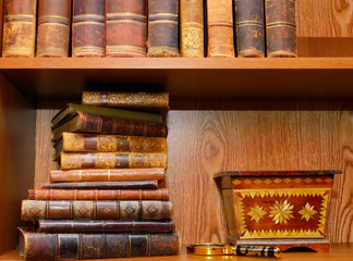 Old books, magnifying glass and box