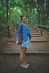 Fototapeta premium Young girl on a walk in the forest