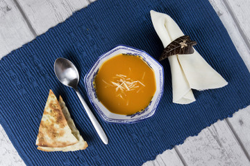 Homemade soup on wooden table, top view