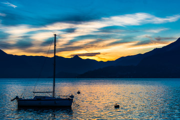 Lake Como at sunset with sailboat