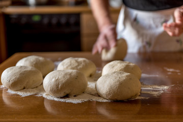 Hands on pieces for dough for pizzas