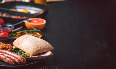 Breakfast on a black wooden table in rustic style