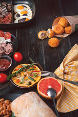 Breakfast on a black wooden table in rustic style