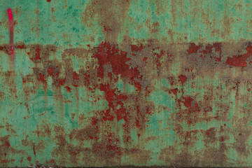 Rusty surface of green metal plate. Rusty texture backdrop. Rust on old metal. Rust on old green fence. Grunge ruststained metal fence. Mildew on green iron-plate fencing. Seedy bingery paling