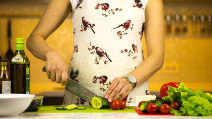 woman preparing a greek salad