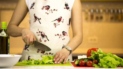 woman preparing a greek salad