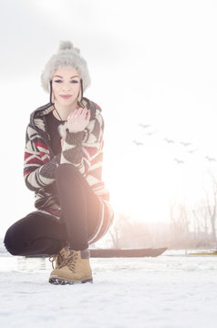 Beautiful Young Girl Crouched On The Icy River, Winter Cold Sunn