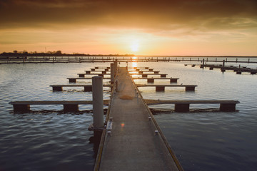 Obraz premium Yacht port over orange sunset