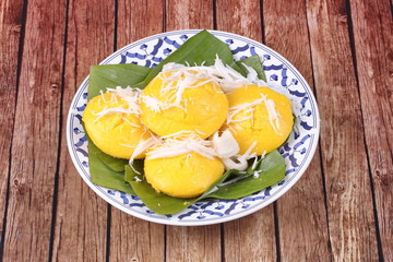 Toddy palm cake topped roll coconut .
