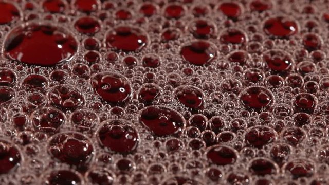 Foam bubbles with fresh cherry juice. Slow motion