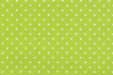 White dot over yellow polka dot fabric background and texture.