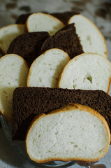 slices of white and black bread lie on a plate