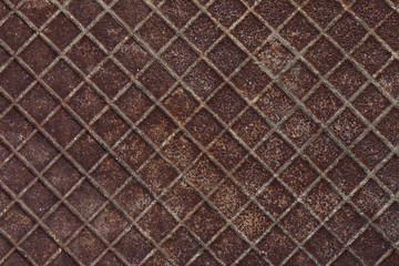 Canal cover surface texture. Rusty iron square pattern. Rusty metal square texture. Robust old iron rusted canal cover wallpaper. Ruststained canal grid form cover backdrop. Ironworks theme background