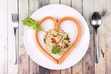 Sausage cheese in heart style with spicy green mango salad.