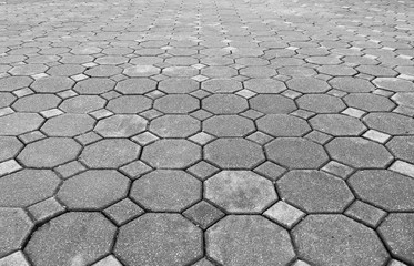 Perspective View of Monotone Grunge Gray Brick Stone on The Ground for Street Road. Sidewalk, Driveway, Pavers, Pavement in Vintage Design Flooring Hexagon Pattern Texture Background