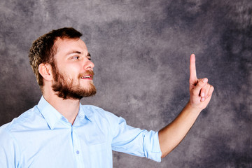 bearded man is surprised and showing forefinger