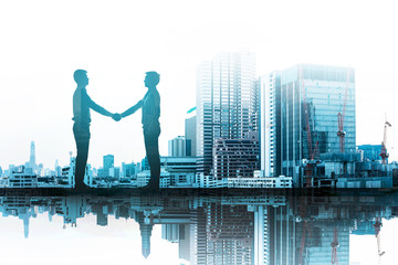 Business handshake with gold scene city in background. Double exposure of handshake and city. Collaboration concept.