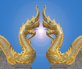 Naga facing each other with flare in blue sky at the temple is a