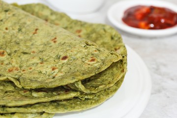 Methi Paratha (Thepla) / Indian flat bread using fenugreek leaves, selective focus