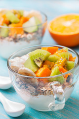 Breakfast with muesli, yoghurt, tropical fruits