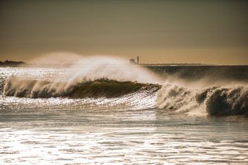 Large wind blow waves roll into Ventura beaches. 