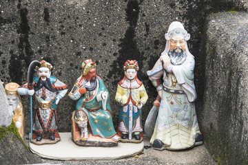 Fototapeta na wymiar Holy statues on the small altar on the street in Tai O village, Hong Kong.